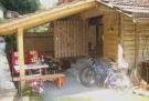 (c) Camping Du Lac: The covered courtyard of the rustic cottage